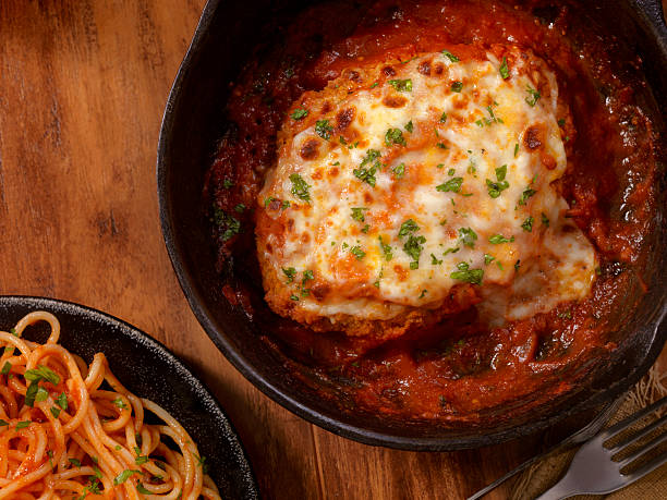 Chicken Parmesan with Spaghetti Chicken Parmesan Baked in Tomato Sauce with Spaghetti Mozzarella Cheese- Photographed on a Hasselblad H3D11-39 megapixel Camera System parmesan cheese stock pictures, royalty-free photos & images