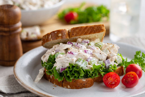 Chicken Salad Sandwich on Whole Grain Bread Chicken salad sandwich with lettuce on whole grain bread and grape tomatoes on a plate chicken salad stock pictures, royalty-free photos & images