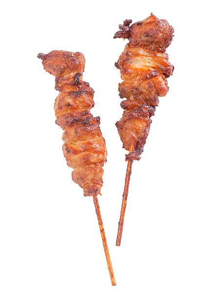 Chicken satay – grilled chicken skewers isolated on white background stock photo