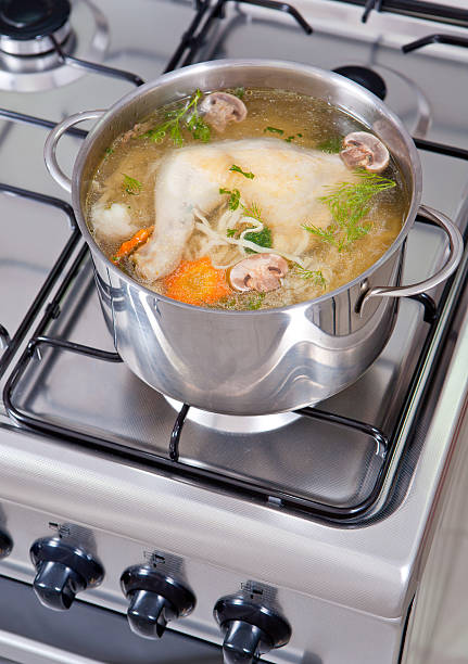 chicken soup being cooked stock photo