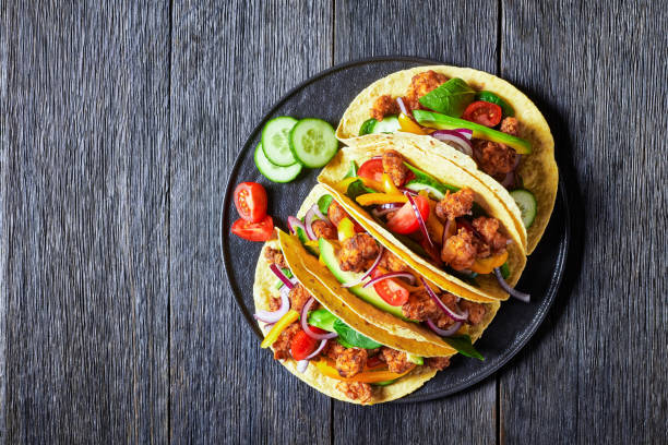 chicken street tacos with avocado, cucumber, fresh spinach leaves, pepper strips and onion on a marble table chicken street corn tacos with veggies and salsa chicken meat photos stock pictures, royalty-free photos & images