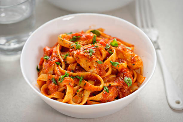 Chicken tagliatelle in tomato sauce Chicken tagliatelle in creamy tomato sauce tagliatelle stock pictures, royalty-free photos & images