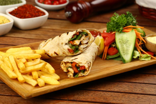 Chicken wrap with fried fries and salad Chicken wrap with fried fries, salad and rice shawarma stock pictures, royalty-free photos & images