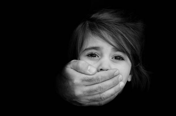 Child abduction - Concept Photo Strong male hands cover little girl face with emotional stress, pain, afraid, call for help, struggle, terrified expression.Concept Photo of abduction, missing, kidnapped,victim, hostage, abused child victim stock pictures, royalty-free photos & images