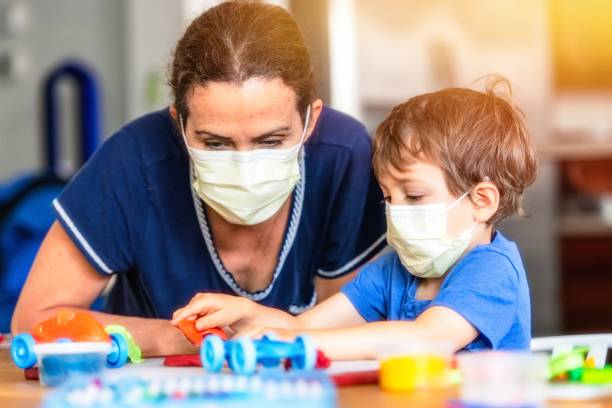 Child boy learning with colorful clays while locked down because pandemic Caucasian Child boy learning with colorful clays using face masks while locked down because pandemic child care stock pictures, royalty-free photos & images