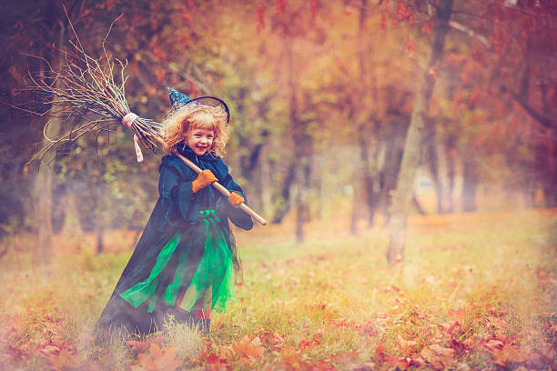 Child celebrating Halloween Little girl dressed as witch at Halloween period costume stock pictures, royalty-free photos & images