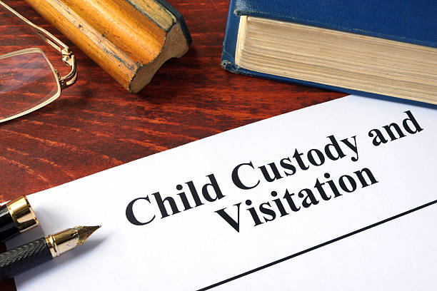 child custody and visitation written on a paper and a book. - echtscheidingsadvocaat  stockfoto's en -beelden