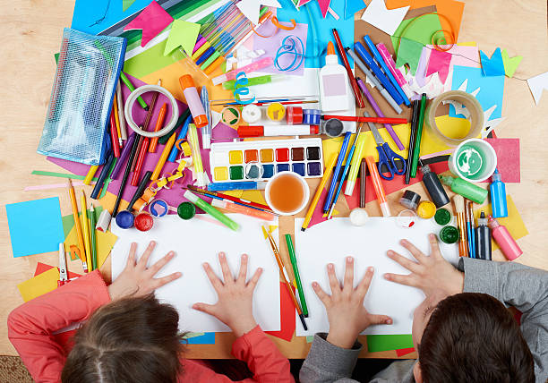 Child drawing top view. Artwork workplace with creative accessories. stock photo