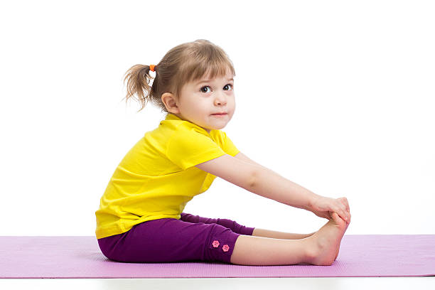 Child girl doing gymnastic exercises stock photo