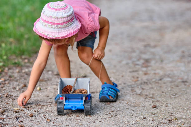 Child girl in summer clothing with toy truck stock photo