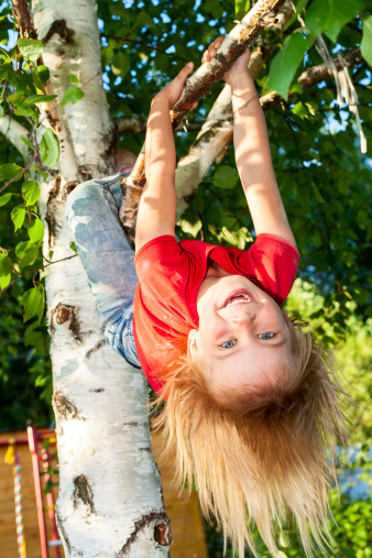 Happy kids hanging on tree in summer park — Stock Photo 