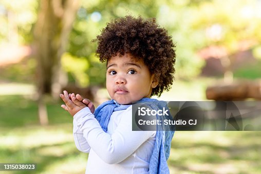 istock Child looking at camera with embarrassment 1315038023