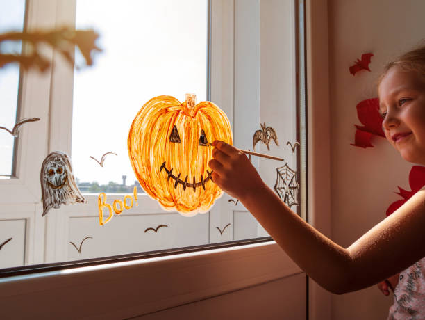 child-painting-pumpkin-on-window-preparing-to-celebrate-halloween-picture-id1340495286?k=20&m=1340495286&s=612x612&w=0&h=kgTg7PmZvFipxHjggP9A3Q3QvuEisit2i8hsdIKR5mQ=