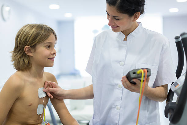 Child performing a stress test with electrodes. Child performing a stress test with electrodes. electrode stock pictures, royalty-free photos & images