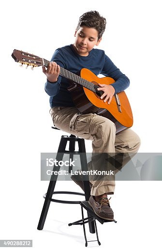 istock Child Playing Guitar on Chair 490288212