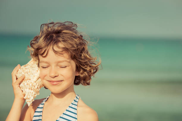 Child relaxing on the beach stock photo