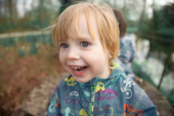 Child smiles face portrait on blurry background, shallow focus stock photo