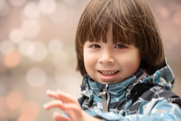 Child smiles face portrait on bokeh background stock photo