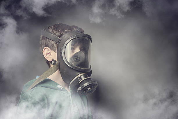 Child wearing a gas mask against air pollution stock photo