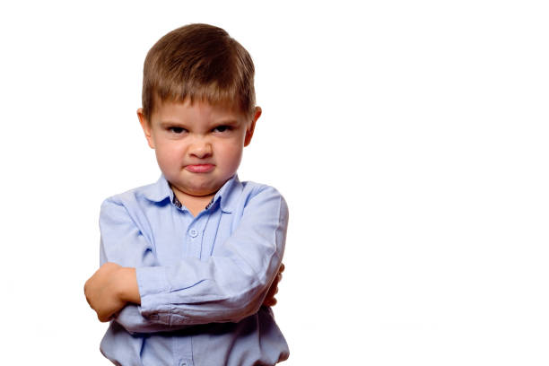 Child with a grimace on his face stock photo