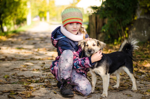 child with animal in autumnal colorful time stock photo