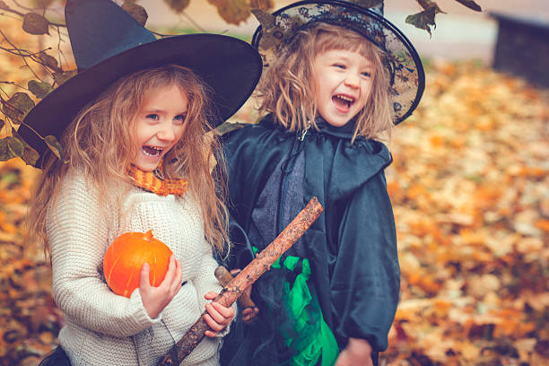 Children celebrating Halloween Little girls dressed as witch at Halloween stage costume stock pictures, royalty-free photos & images