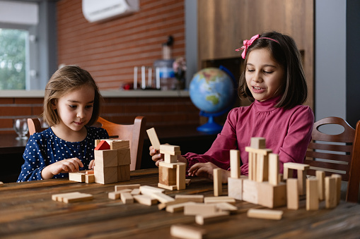 Children Playing With Wooden Toy Blocks At Home