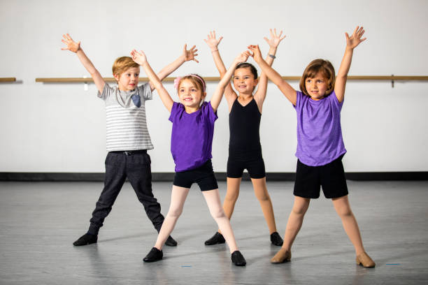 Children practicing musical theater in studio A cute group of children practicing musical theater in a dance studio musical theater stock pictures, royalty-free photos & images