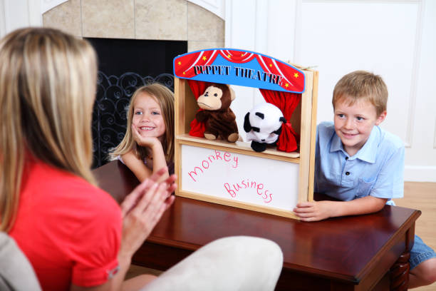 Children Putting On Puppet Show XXXL.  Young children putting on a puppet show for their mother. gchutka stock pictures, royalty-free photos & images
