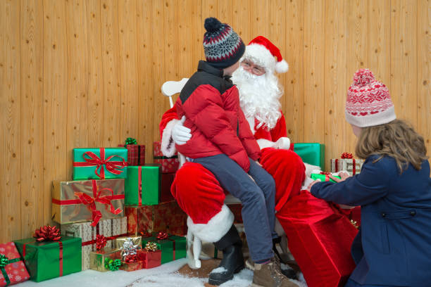 Children visiting Santas grotto Children visiting Santa in his Christmas grotto shopping mall photos stock pictures, royalty-free photos & images