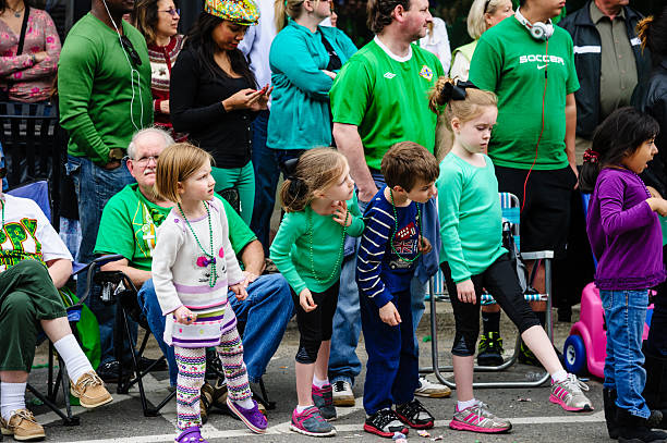 Children watching St. Patrick's Day parade stock photo