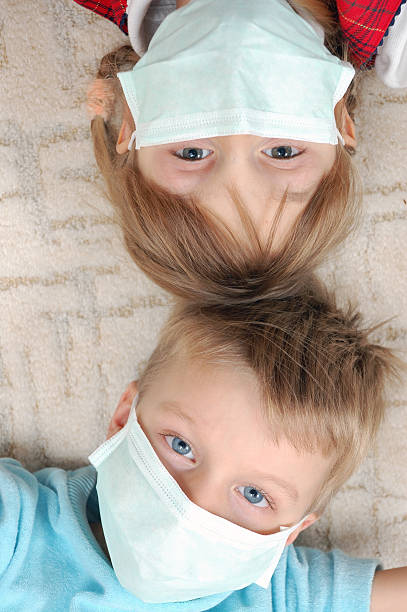 children with pretection flu mask stock photo