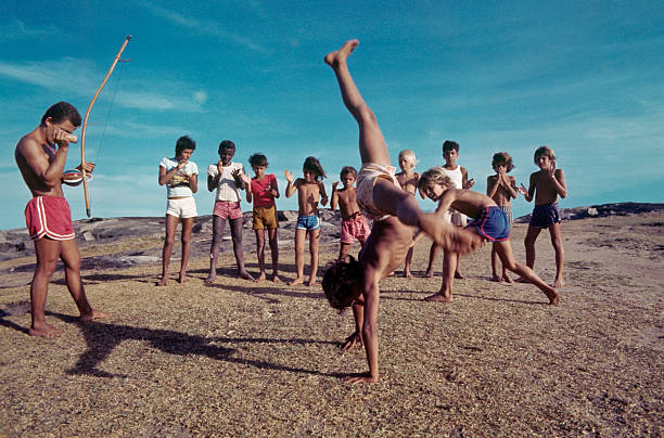 children with teacher, practicing capoeira. stock photo