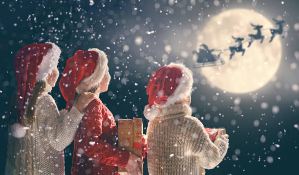 children with xmas presents - christmas magic imagens e fotografias de stock