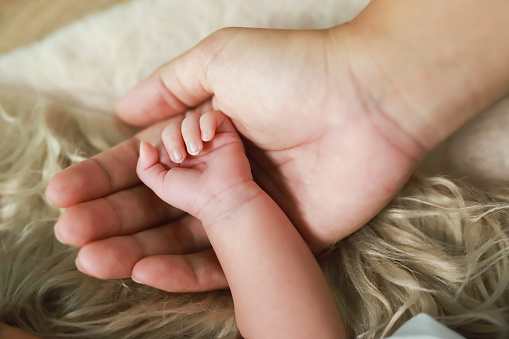 Children's hands with the warmth of mother's care