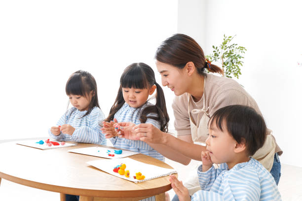 Children's nurse and kindergarten child Children's nurse and kindergarten child learning center for children stock pictures, royalty-free photos & images