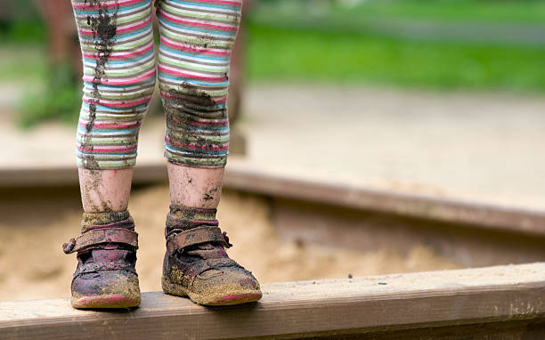 child's muddy feet - muddy shoes stockfoto's en -beelden
