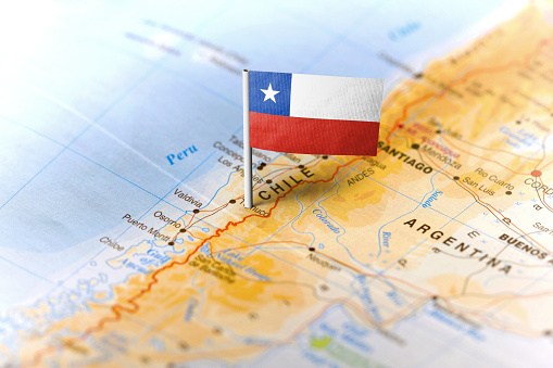 The flag of Chile pinned on the map. Horizontal orientation. Macro photography.