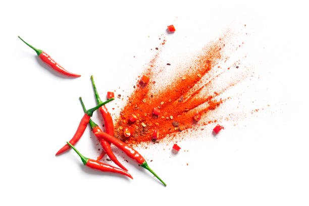 Chili, red pepper flakes and chili powder burst Chili, red pepper flakes and chili powder burst cayenne pepper photos stock pictures, royalty-free photos & images