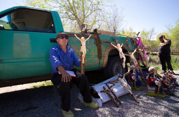Chimayo, NM, USA: Man Selling Crucifixes at Good Friday Pilgrimage  good friday stock pictures, royalty-free photos & images