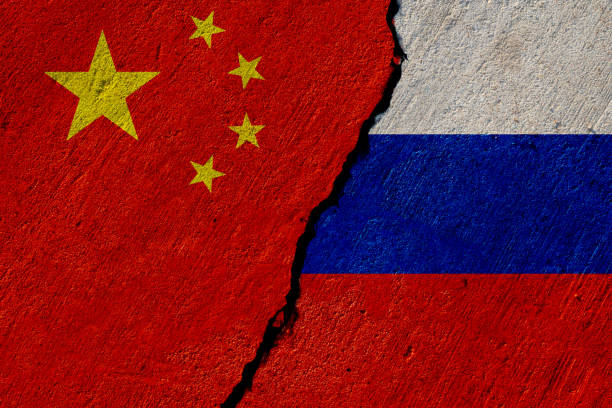china and russia flags painted on concrete wall stock photo