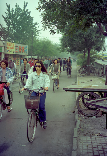 Beijing, China - Oct 11, 1995: A lot of Chinese commuter ride on bicycles in the morning rush hour in the 1990s