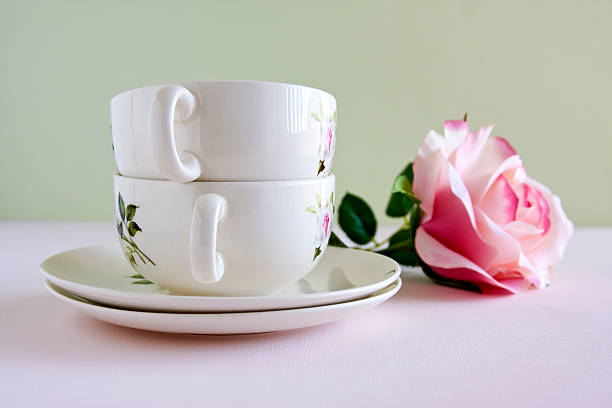 China Teacups and a Single Pink Rose Flower stock photo