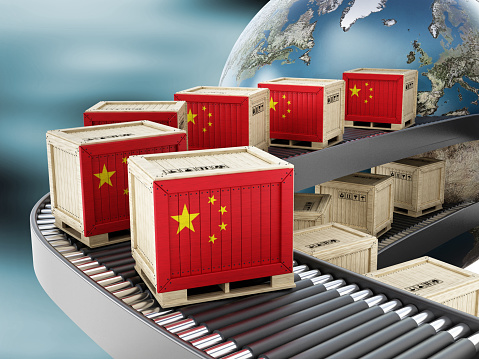 Tansport crates with Chinese flag on the conveyor belt. Global exportation concept.