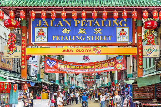 Chinatown in Kuala Lumpur Kuala Lumpur, Malaysia - September 18, 2015: Crowds pass below the main gate of Chinatown at Petaling Street. chinatown kuala lampur stock pictures, royalty-free photos & images
