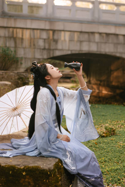 Chinese Han costume beauties drinking by the lake Chinese Han costume beauties drinking by the lake ::::: asian beauties : stock pictures, royalty-free photos & images