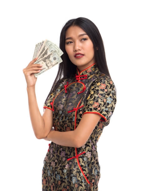 Chinese new year asian woman concept, isolated asian woman wearing red dress(cheongsam) holding dollars money Chinese new year asian woman concept, isolated asian woman wearing red dress(cheongsam) holding dollars money quan yuan stock pictures, royalty-free photos & images