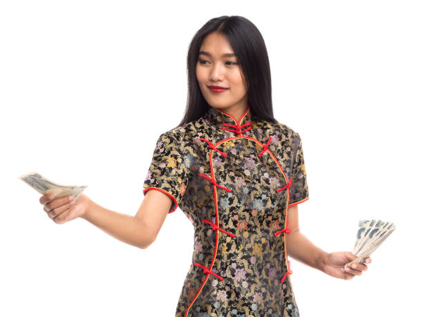 Chinese new year asian woman concept, isolated asian woman wearing red dress(cheongsam) holding yuan money Chinese new year asian woman concept, isolated asian woman wearing red dress(cheongsam) holding yuan money quan yuan stock pictures, royalty-free photos & images