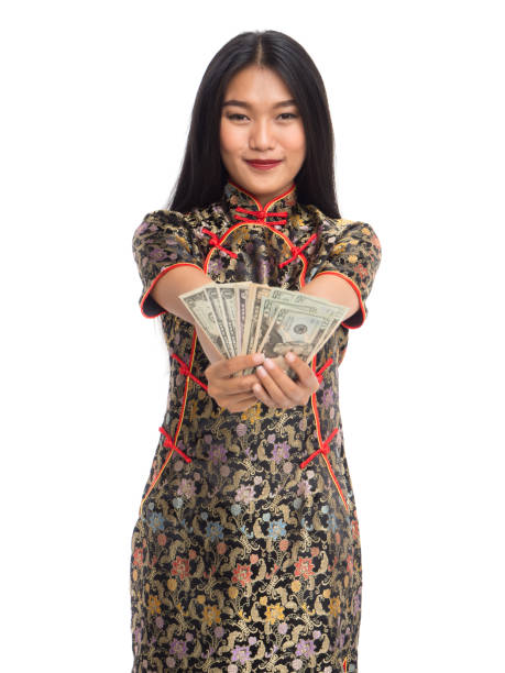 Chinese new year asian woman concept, isolated asian woman wearing red dress(cheongsam) holding dollars money Chinese new year asian woman concept, isolated asian woman wearing red dress(cheongsam) holding dollars money quan yuan stock pictures, royalty-free photos & images