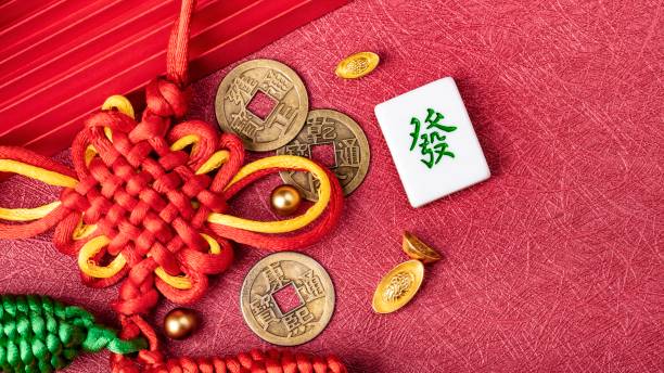Chinese New Year Ornament. Auspicious artificial products on red background,  Happy New Chinese Year. Chinese text: Make a fortune and money. copy space, flat lay. Chinese New Year Ornament. Auspicious artificial products on red background,  Happy New Chinese Year. Chinese text: Make a fortune and money. copy space, flat lay. chinese lucky coins stock pictures, royalty-free photos & images